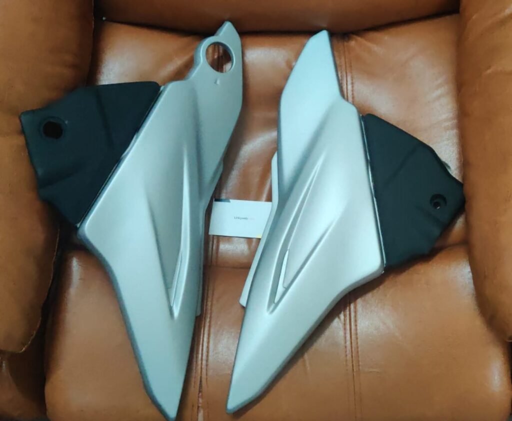 bajaj discover st side panel in silver finish displayed for motorcycle owners