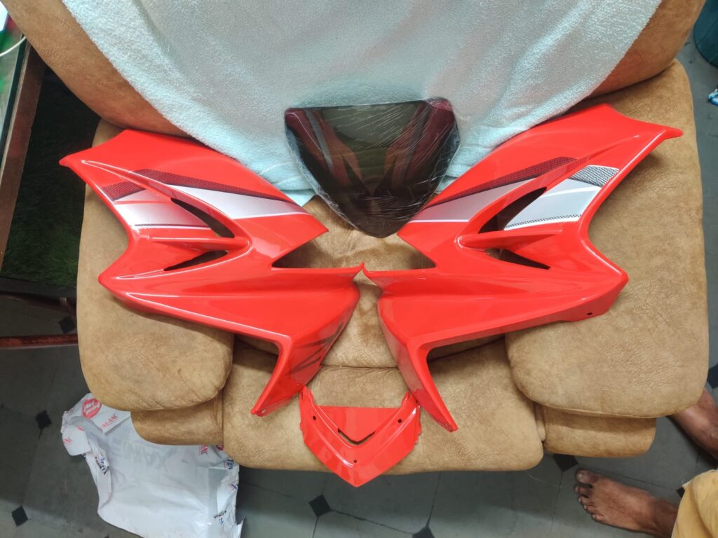 Bright red hero karizma r headlight visor mask fairing made of durable fiber.