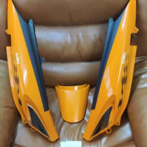 hero glamour tail panel orange replacement part resting on a workbench