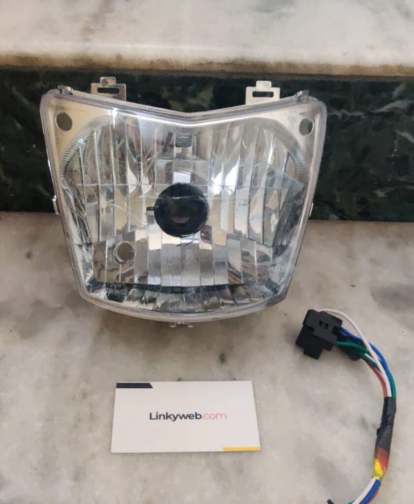 Hero Splendor Pro Head Light Assembly front view showing lens and housing