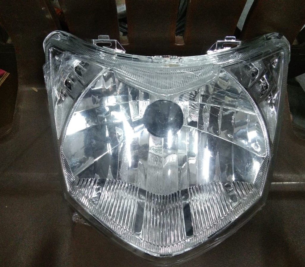 Honda stunner headlight assembly complete unit showing lens, reflector, and housing.