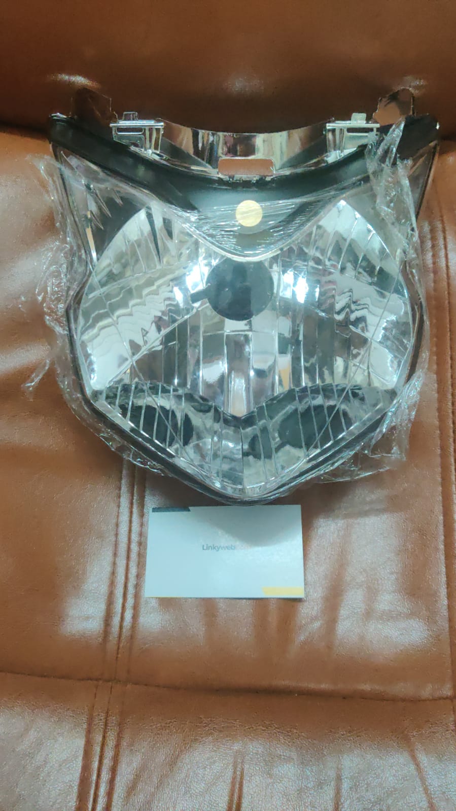 Honda Twister Headlight Assembly featuring clear lens and black housing