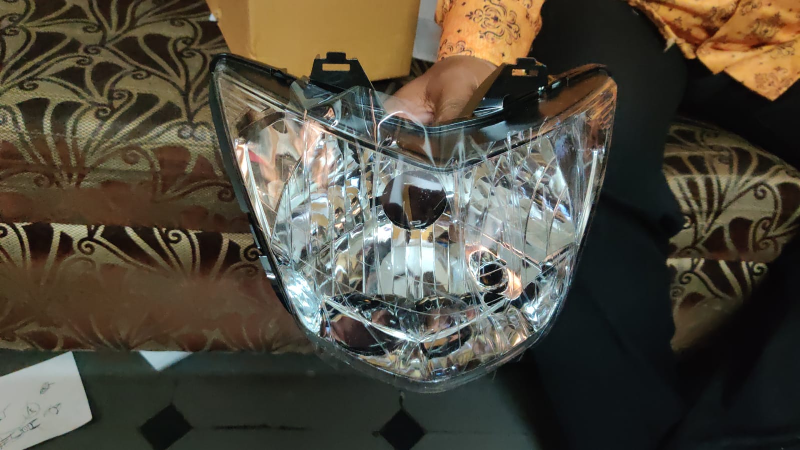 Honda Unicorn headlight assembly front view showing durable ABS plastic housing and lens