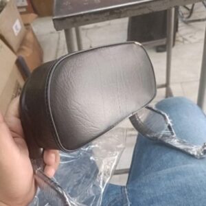 Black ola electric back rest mounted on a scooter for comfortable riding support