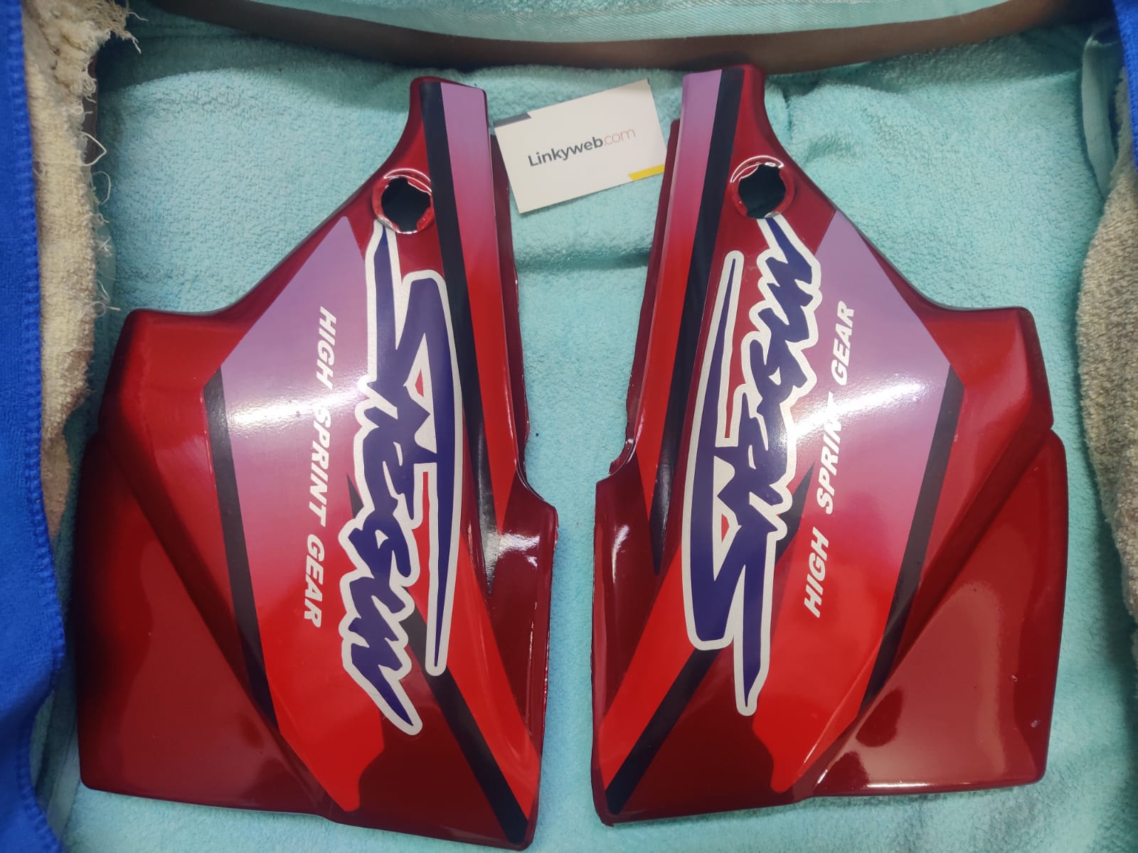 Suzuki Shogun red side panel showing vibrant finish and durable build