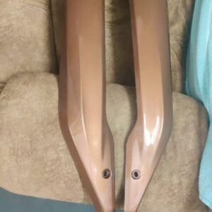 tvs jupiter foot guard trim brown viewed from the side showing smooth brown finish