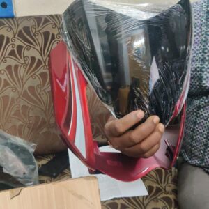 tvs star sport red visor mounted on a motorcycle front assembly