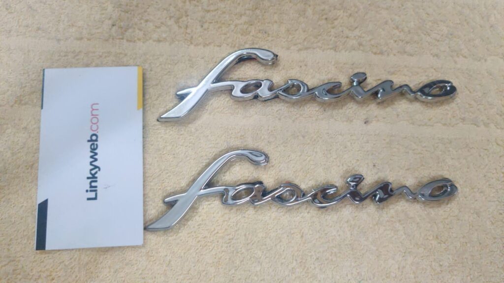 Close-up view of shiny yamaha fascino logos packaged for easy installation.