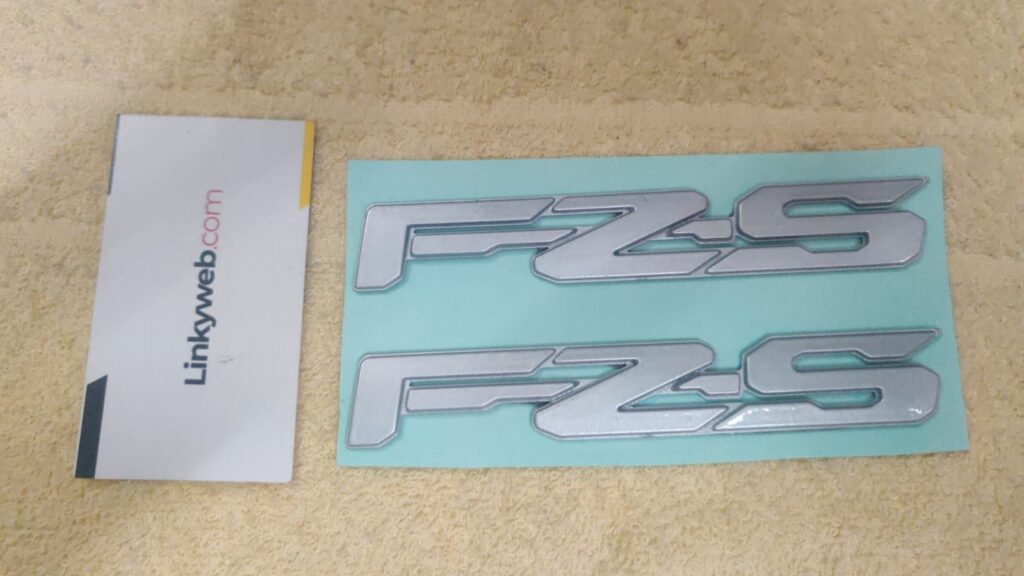 Yamaha fz-s silver logo emblem shown in close-up detail.