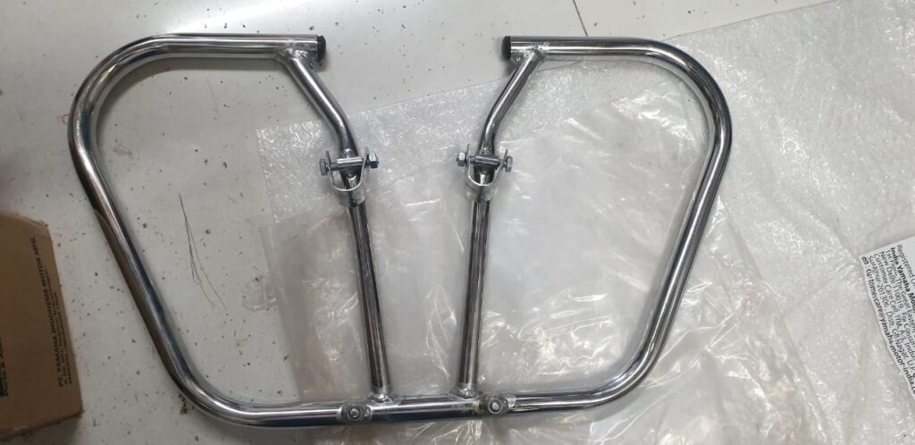 Sturdy black metal yamaha rx 100 leg guard resting on a neutral surface