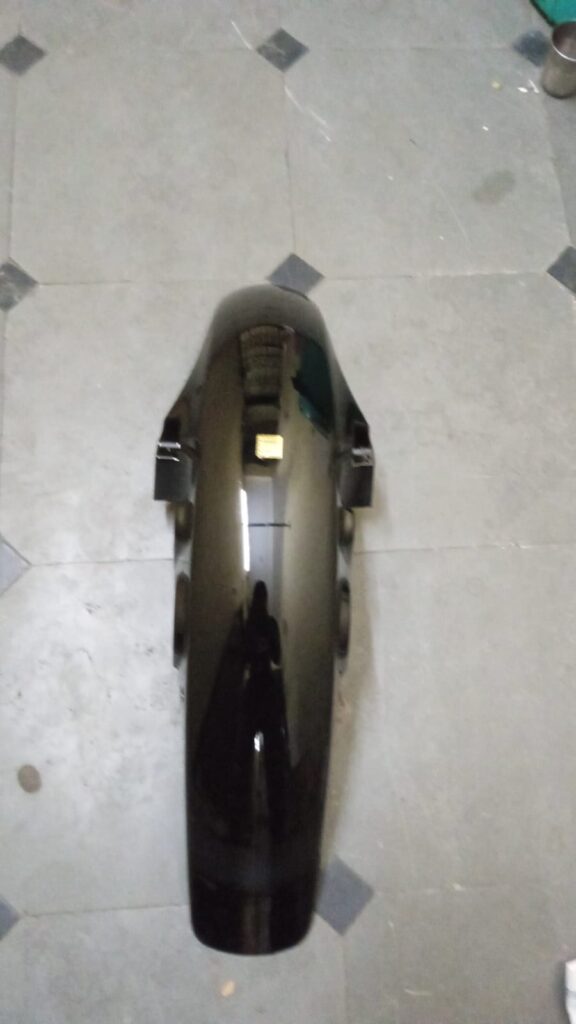Glossy black dream neo front mudguard showing durable ABS construction and mounting slots.
