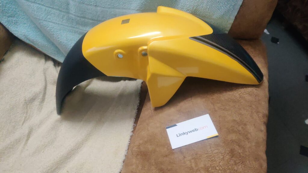 tvs apache front mudguard yellow made of durable ABS plastic mounted on display